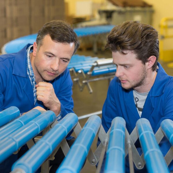 Two men inspecting machine